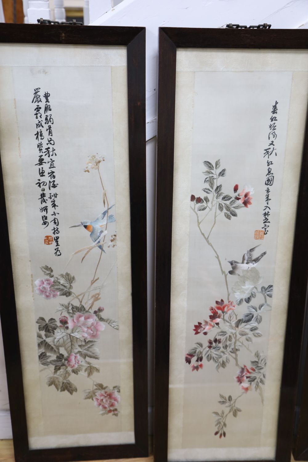 A set of four Chinese embroidered silk pictures worked with birds on flowering branches, each 119 x 38.5cm (overall)